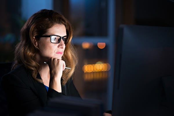Woman examines computer screen